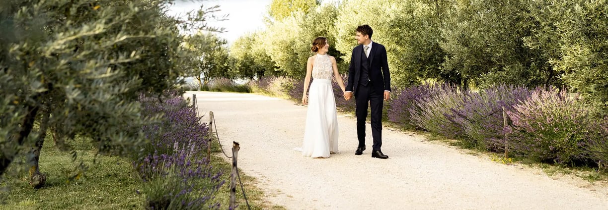 Bride and groom walking in lavender field — editorial fine art wedding photographer South of France