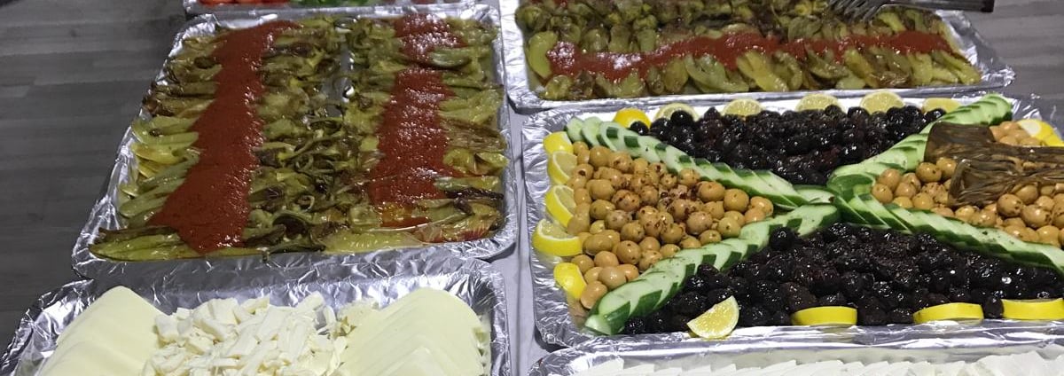 a buffet table with lots of food and people