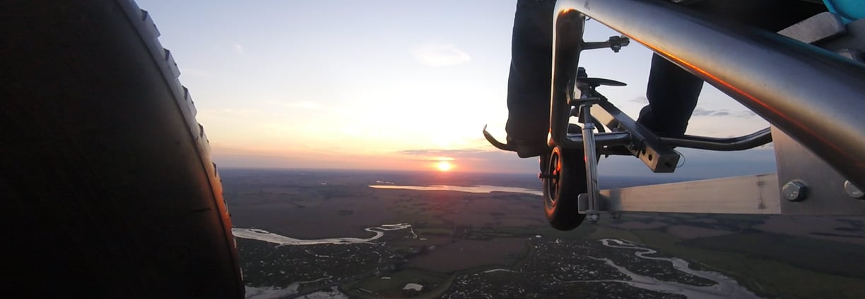 A paramotor trike flying over Mersea Island Essex