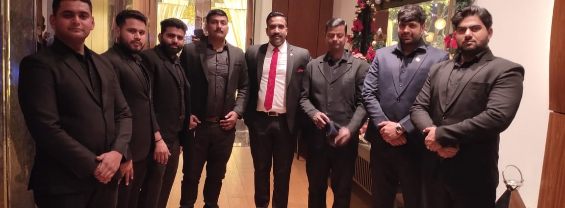 a group of men in suits and ties standing in a room