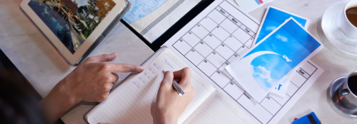 Close-up shot of unrecognizable couple taking necessary notes and planning luxury cruise vacation w