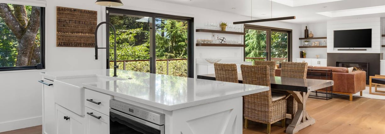 a kitchen with a large window and a table with chairs