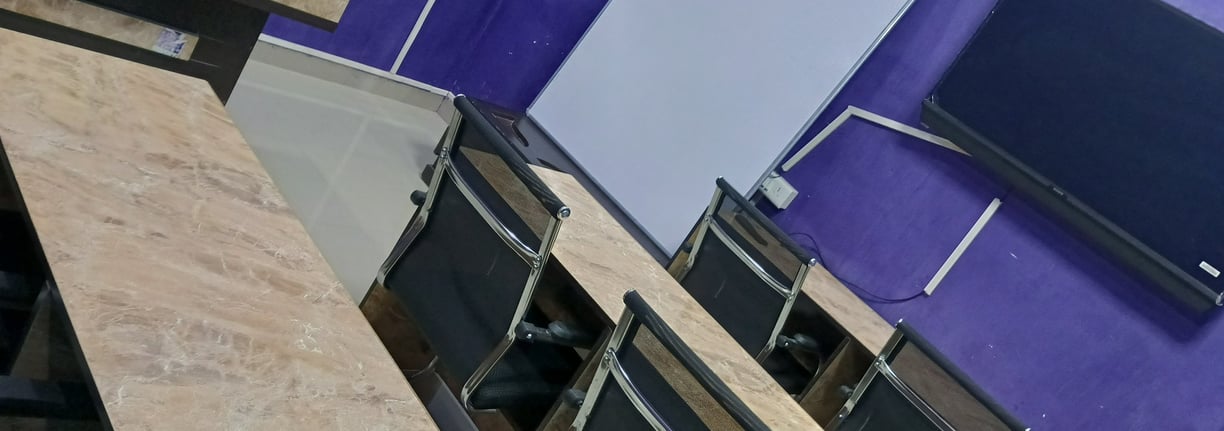 a room with a table and chairs and a television