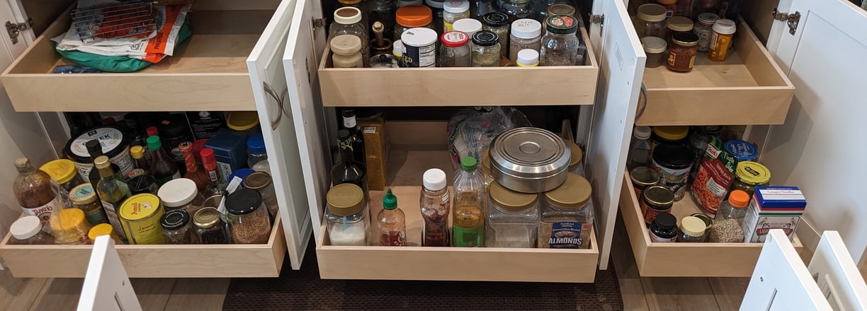 Kitchen roll out shelves that maximize available storage space.