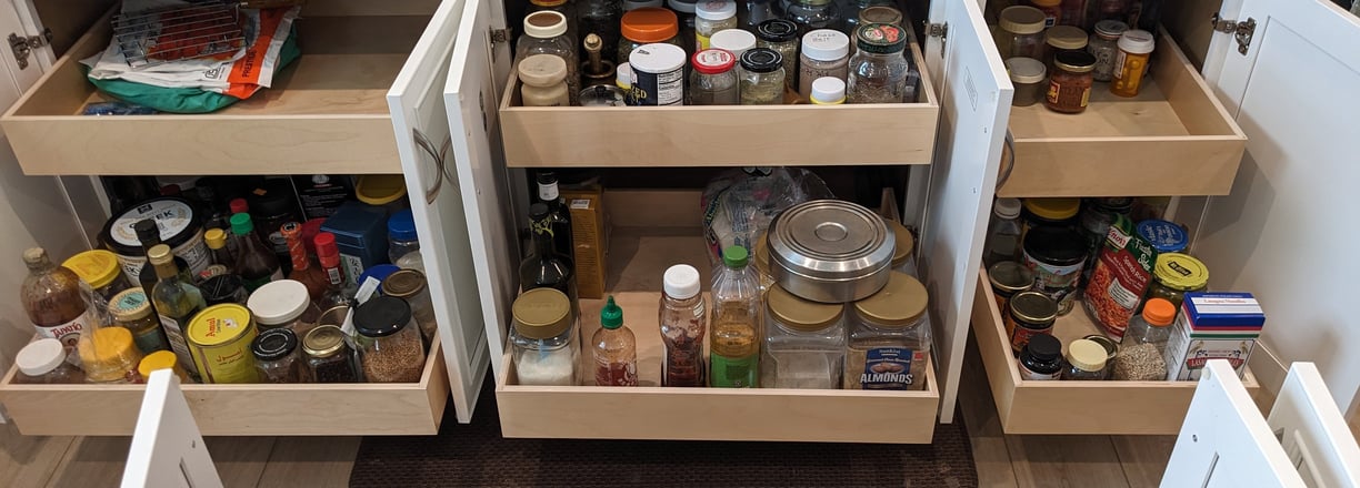 Kitchen cabinets with pull-out shelving to maximize available storage space.