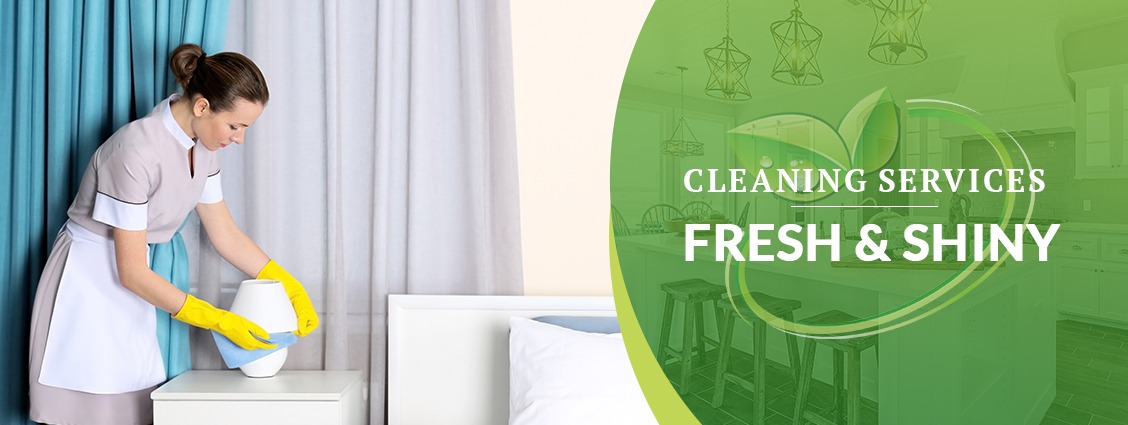a maid maid cleaning a bed in a hotel room