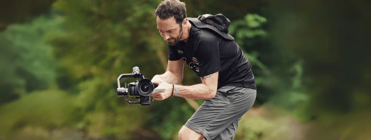 cameraman using gimbal in tropical forest