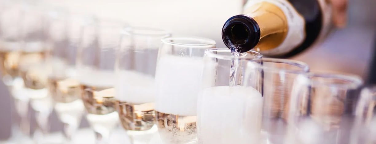 Bartender pouring champagne into flutes in preparing for a wedding toast - Premier Event Staffing
