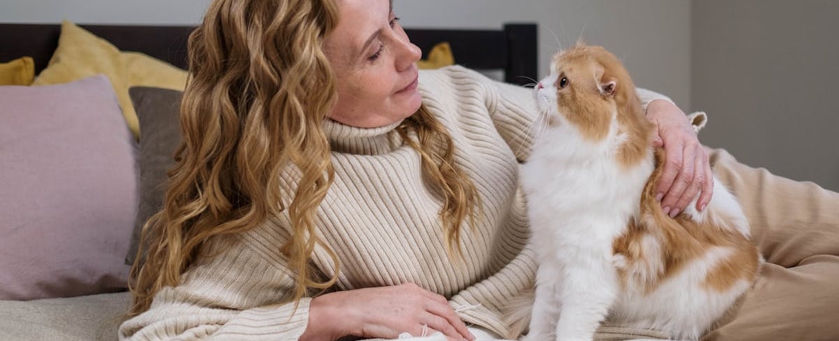 A woman holding a cat