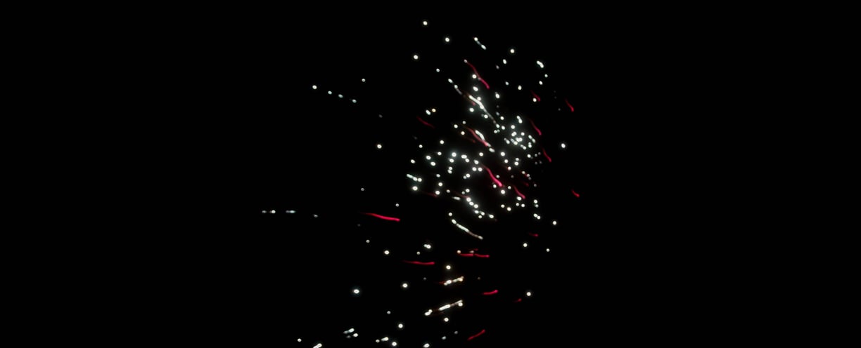 Red and white fireworks in a black sky