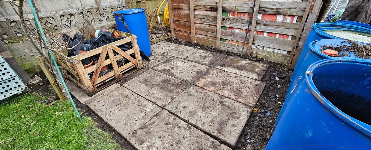a wooden pallet with a crate of wood and paved area