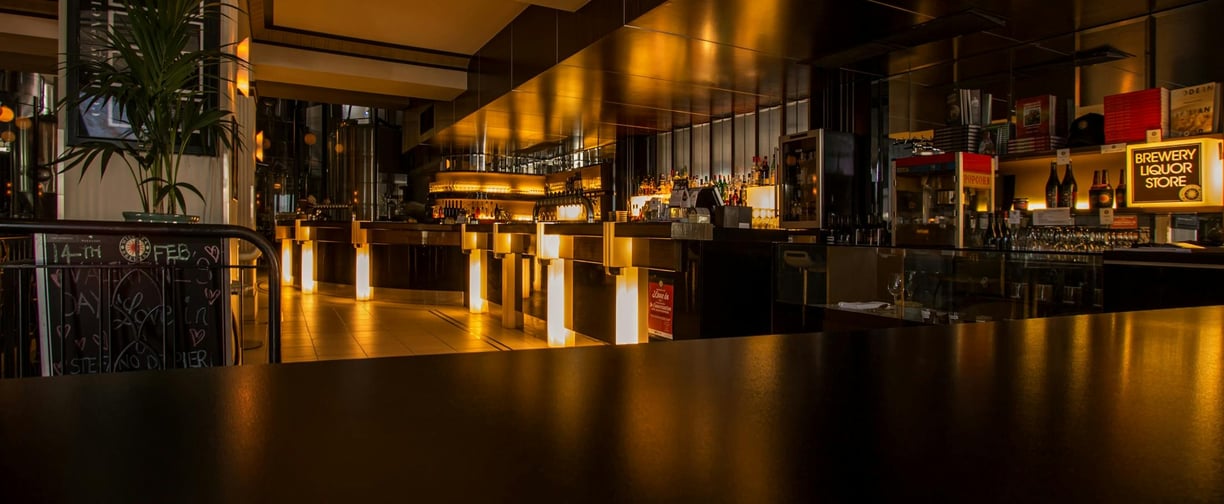 Interior of a modern restaurant and bar for sale, showcasing prime commercial real estate.