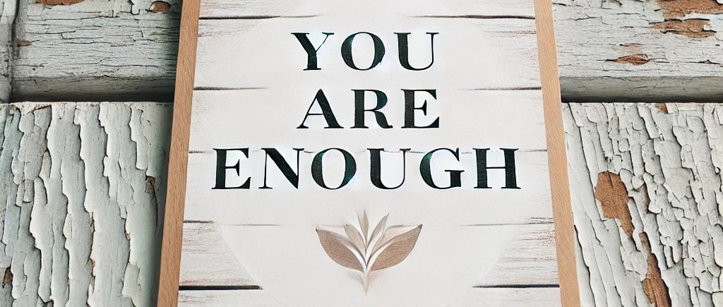Inspirational wooden sign reading 'YOU ARE ENOUGH' against a peeling white painted wood background.