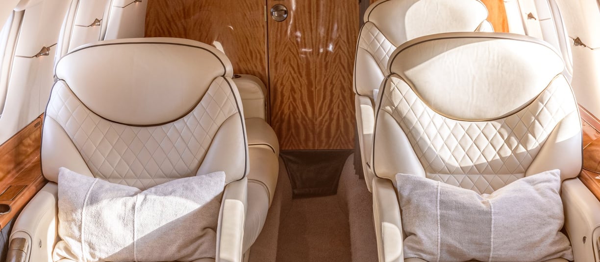 Hawker 800XP cabin interior with luxury leather seating and ambient lighting
