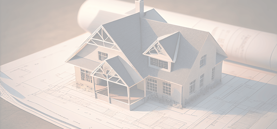 a house model of a house on top of a blueprint