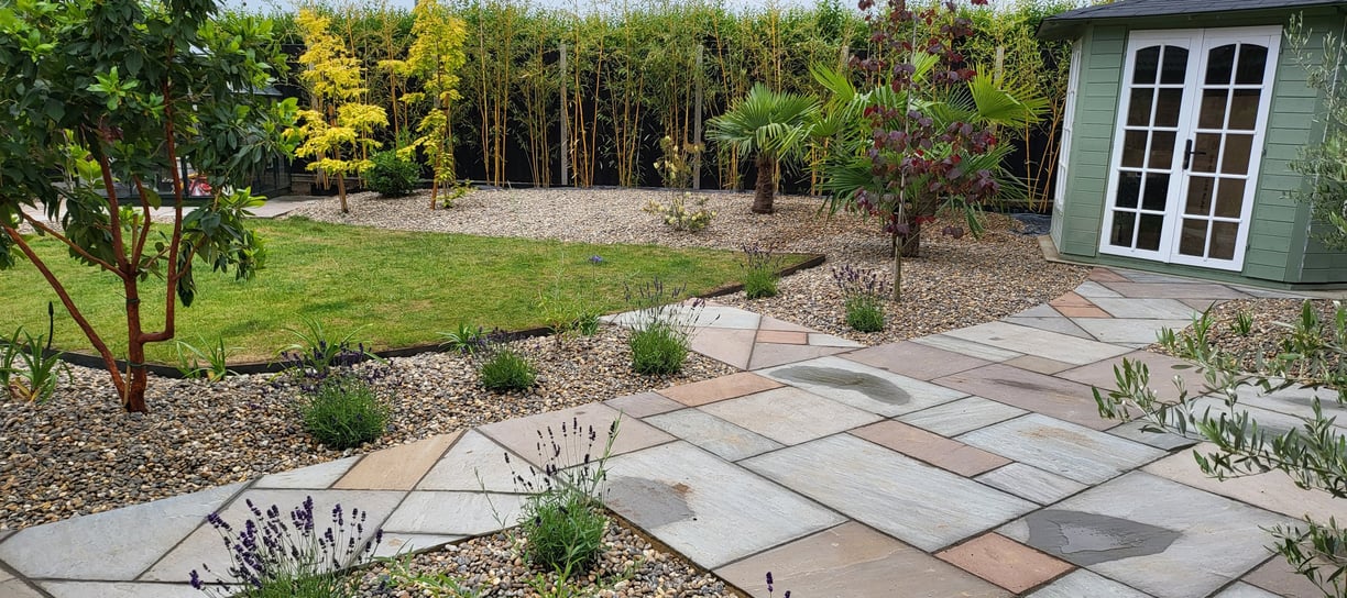 A lawn surrounded by mature planting in hemsby, norfolk