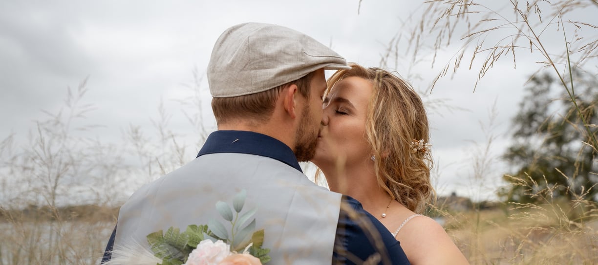 a man and woman kissing in a field