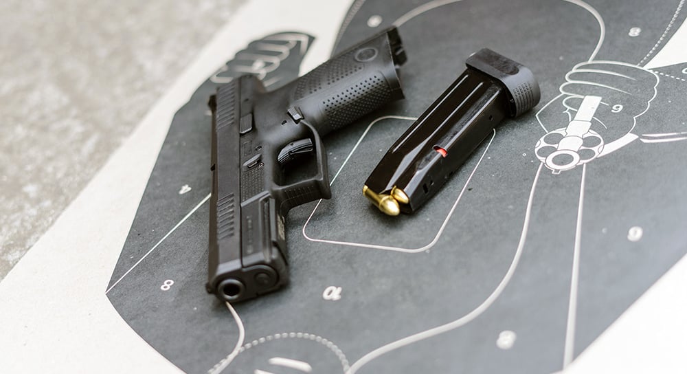 Unloaded firearm and magazine laying on a tactical target