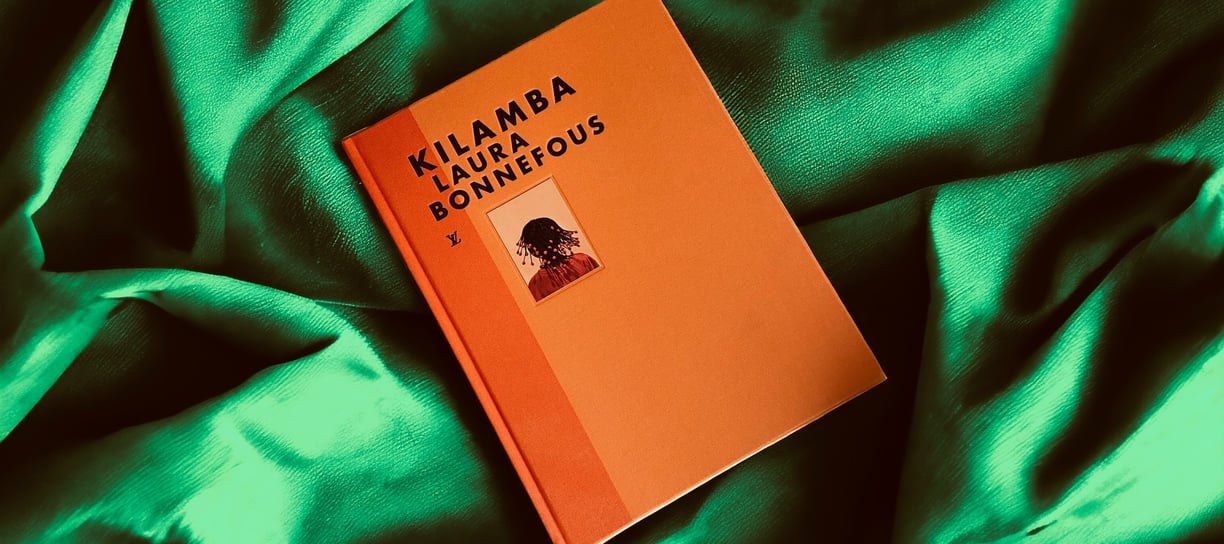 a book with a book cover and a book on a green blanket