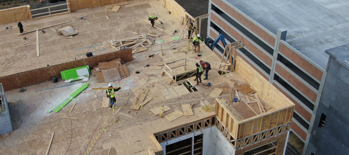 a group of people standing on top of a building
