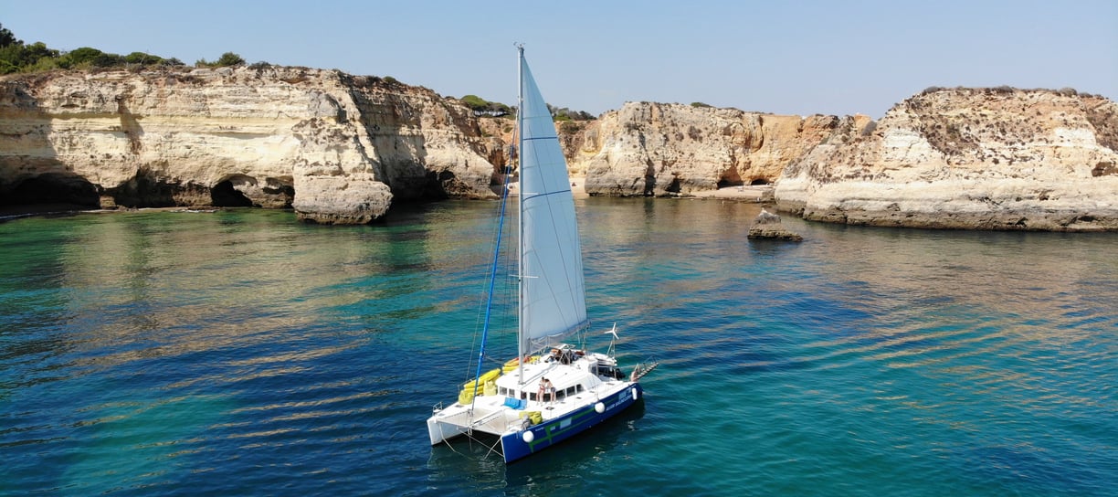 a sailboat in the water with a sailboat in the background