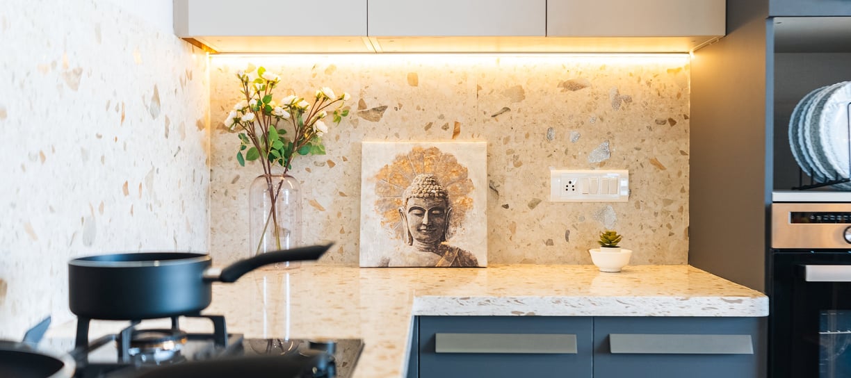 a kitchen design with a stove top oven and a potted plant in Bengaluru