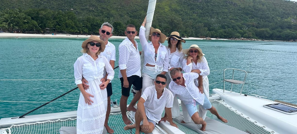 Family dressed in white posing on a catamaran - Catamaran Fishing Charters Seychelles