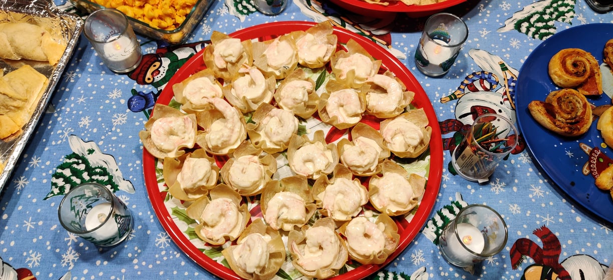 A top down view of Christmas platter full of Mango-Curry Shrimp Salad in Wonton Cups at a party