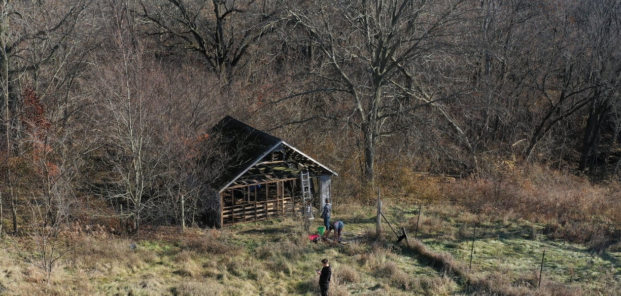 An aerial drone photo of an abandoned and decaying wood structure