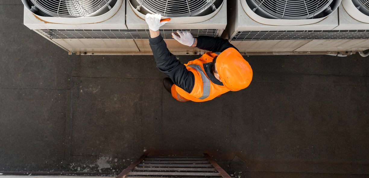a man in a safety vest is standing on a ladder
