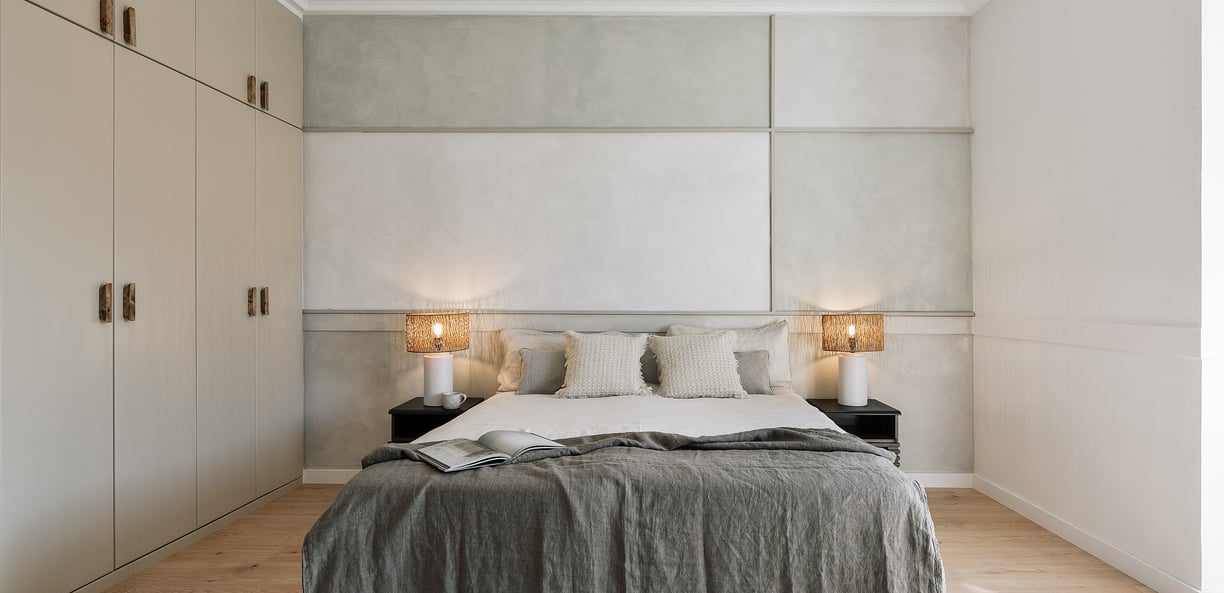 Elegant bedroom with subtle wall art, and calm beige tones, designed by SAVIA in Barcelona