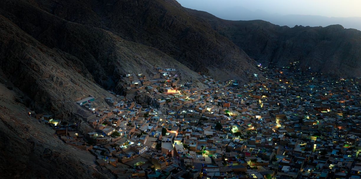 a cityscape of a mountain with a view of a city