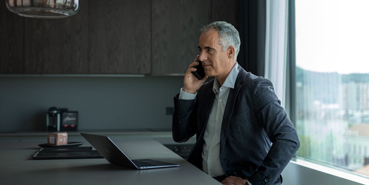 a man in a suit and tie is talking on the phone