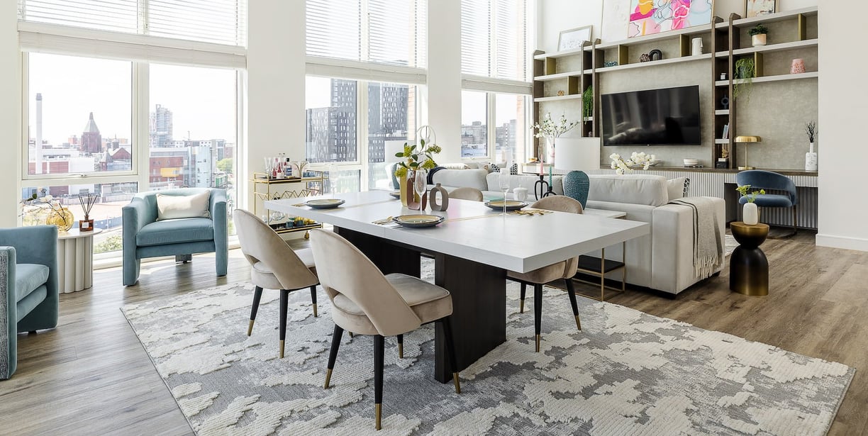 a living room with a large table and chairs