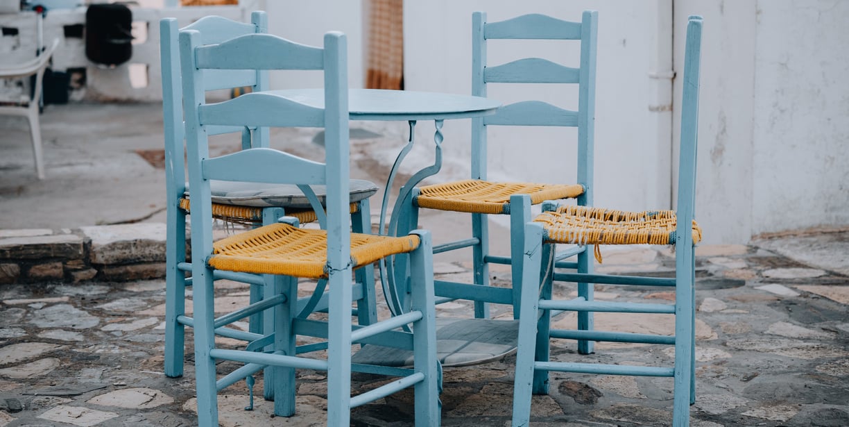 a table with chairs and chairs and a dog