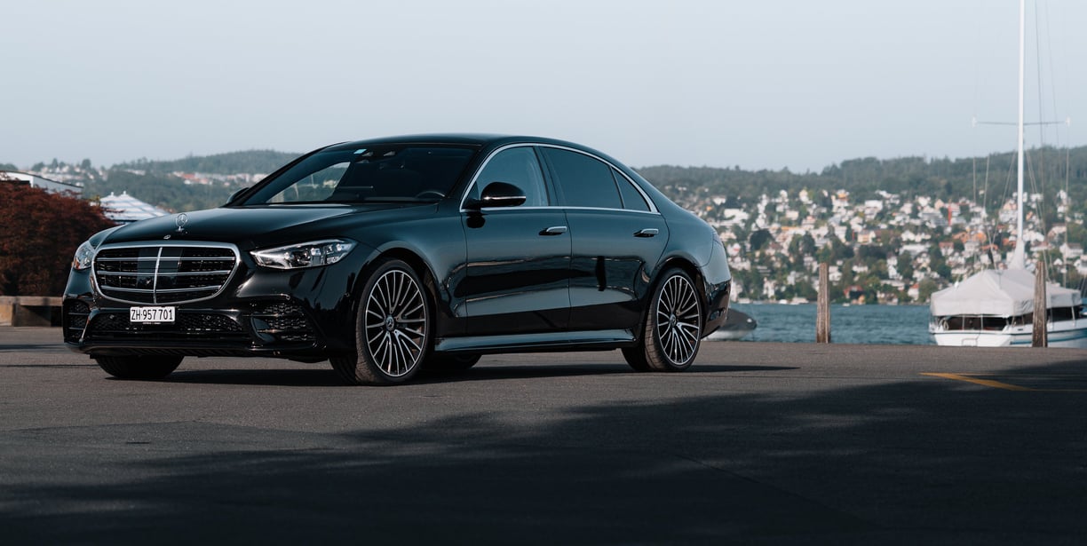 a black mercedes s class on lake zurich