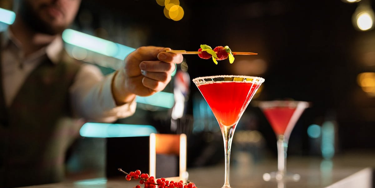 man making cocktail in a bar