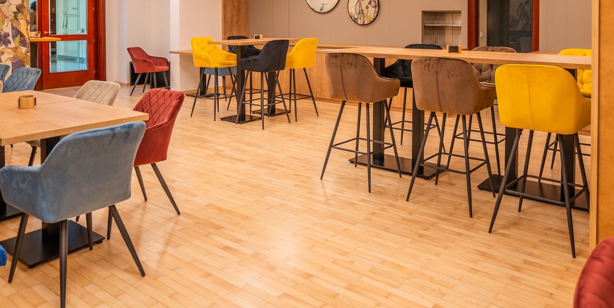 a room with a table and chairs and a clock