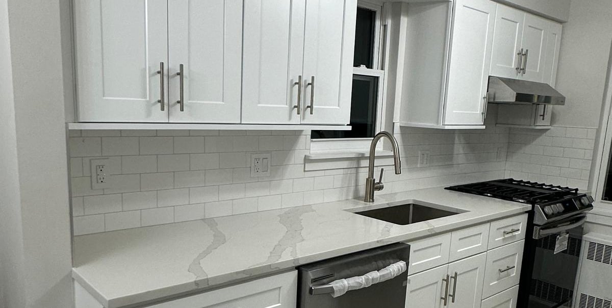 a kitchen with white cabinets and white cabinets