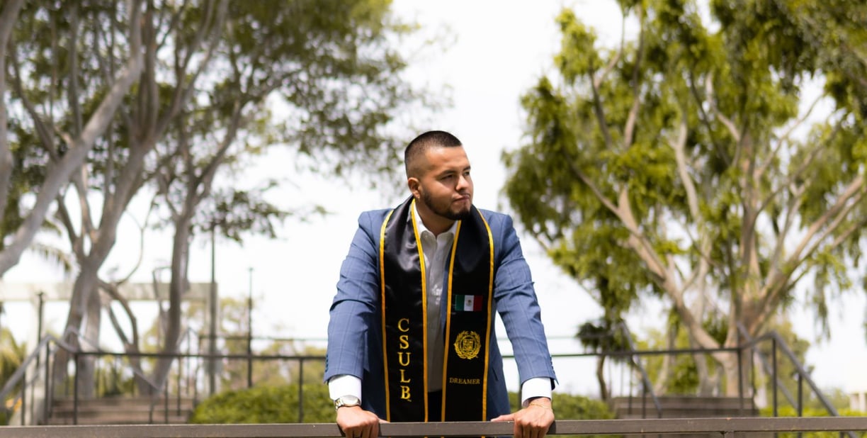 Jose Roldan in a graduation gown and caprisp at CSULB