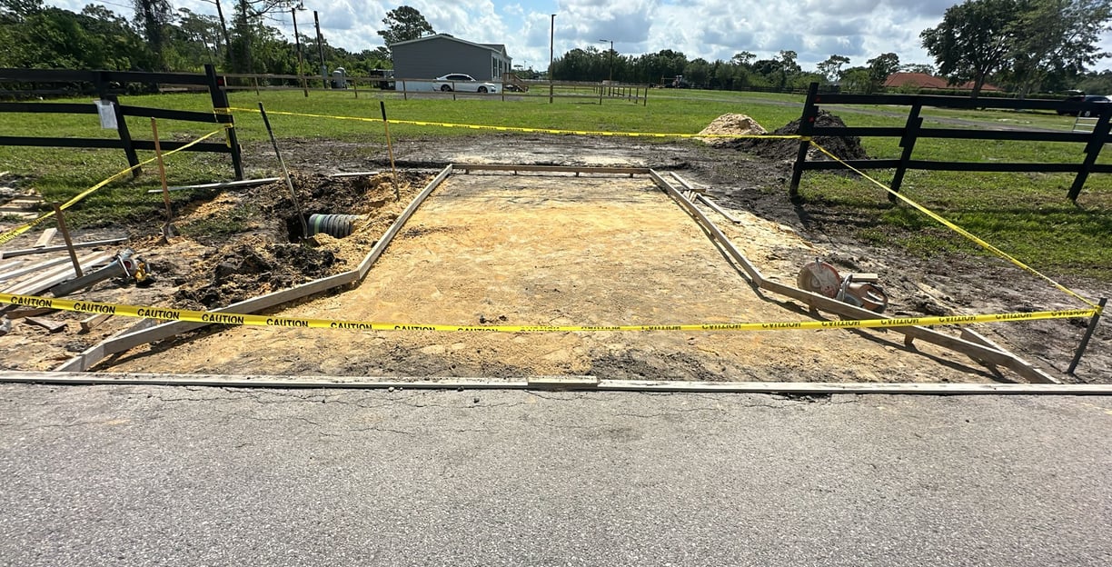 Concrete driveway construction in Kissimmee, FL with reinforced foundation and clean edge finishing