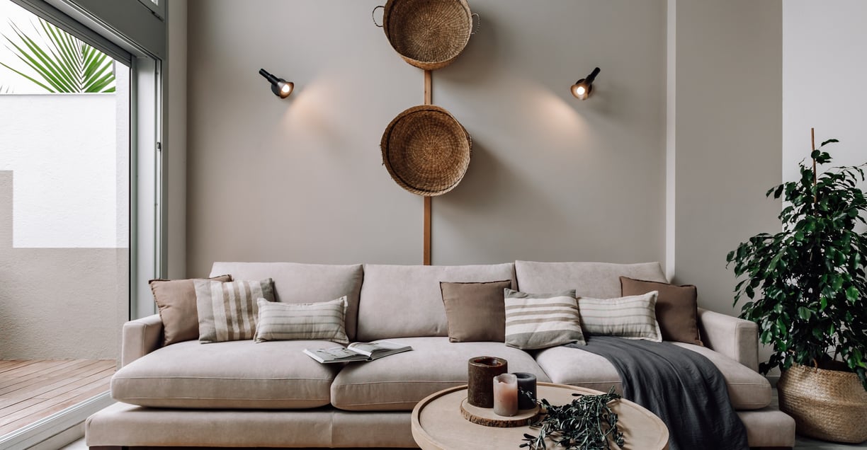 Living area with wooden elements, natural fibers and calm color palette in Barcelona interior design