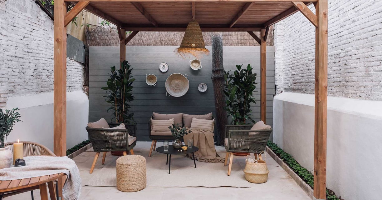 Outdoor terrace with seating and green plants, offering a serene atmosphere in Barcelona apartment