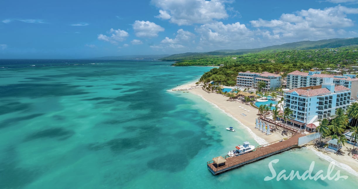 Sandals a beach resort with a pier