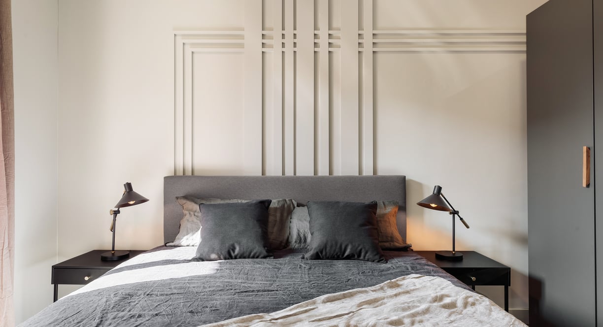 Elegant bedroom with wall panels, calm color palette and modern minimalist design in Barcelona