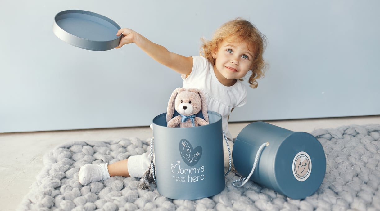 Cute and gentle Logo and Brand Identity for baby store Mommy's Hero, gift box, happy girl