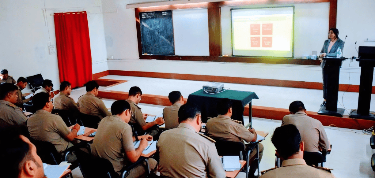 Trainer presenting to uniformed professionals during a classroom session.