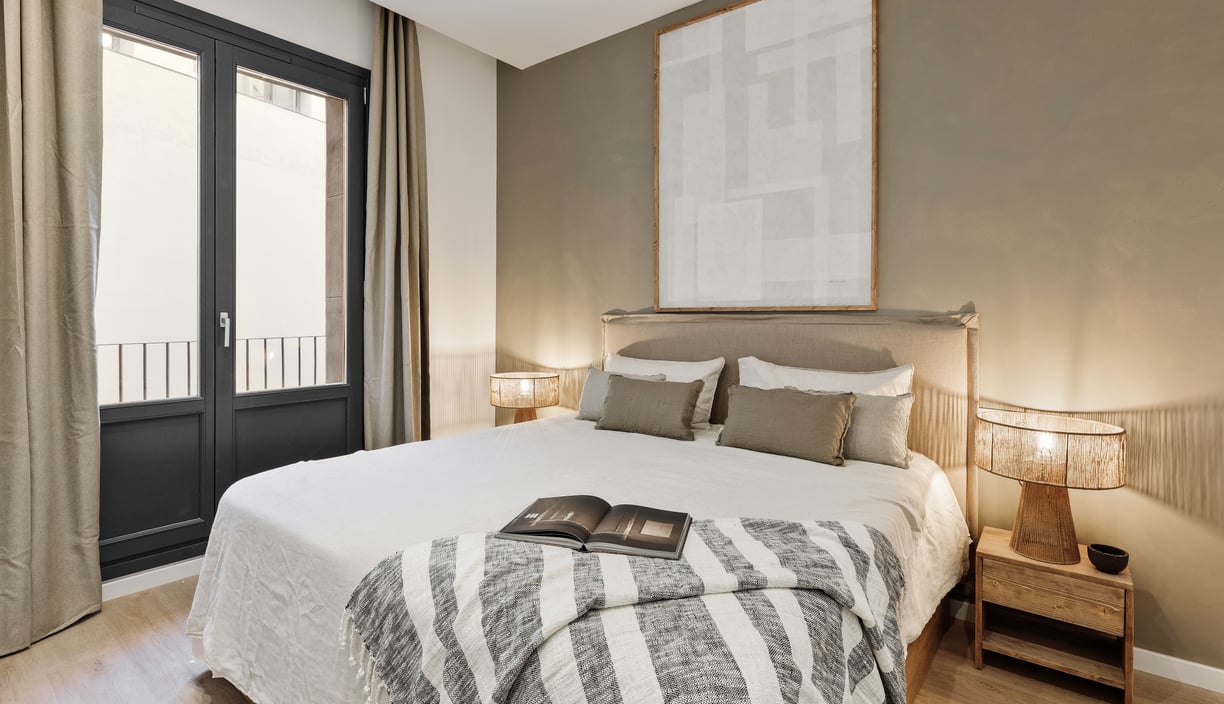 Elegant bedroom with custom artwork and brown and beige colour palette in Barcelona