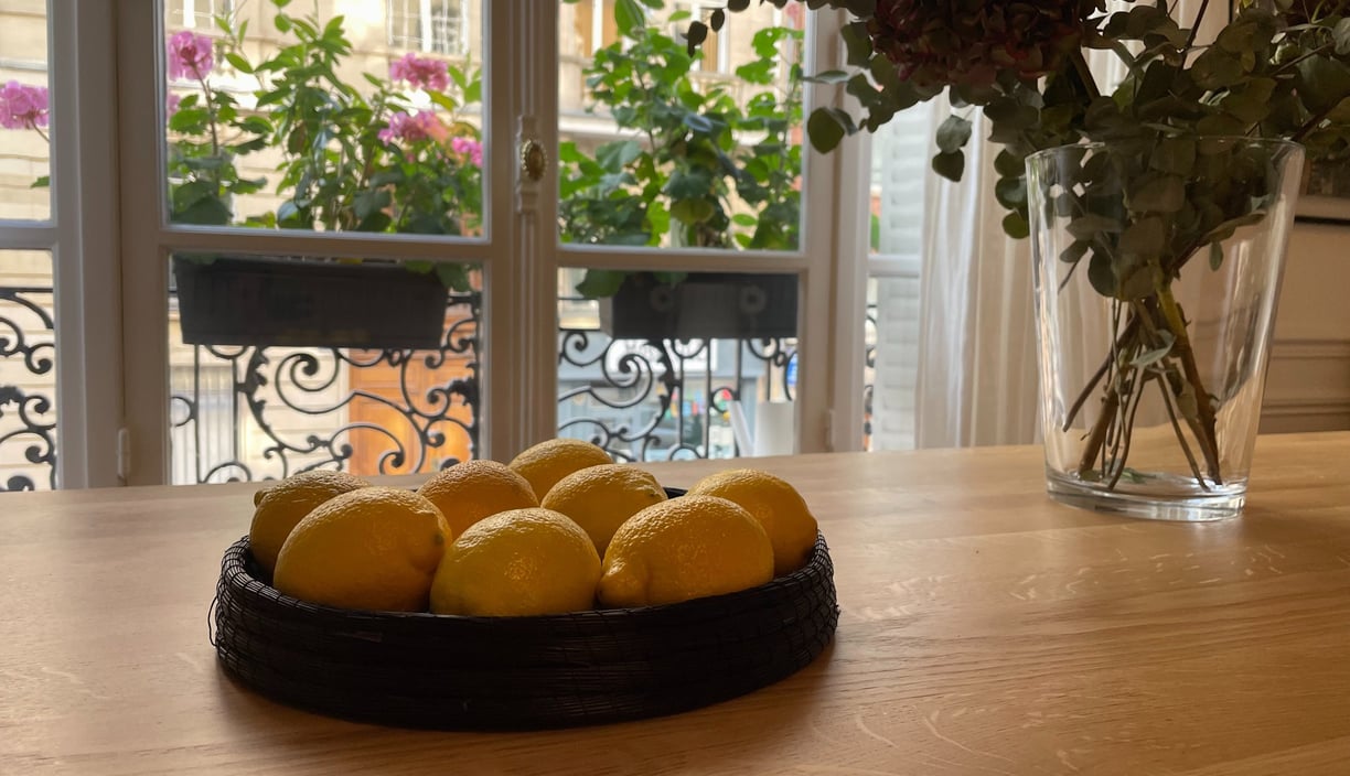 a bowl of lemonade and a vase of flowers