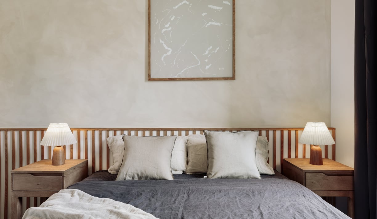Stylish bedroom with natural textures, custom headboard, and calming color palette interior design